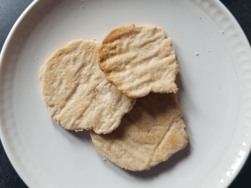 A photograph of three fork-pressed wafers on a white ceramic plate.