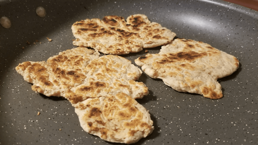 A photograph of three sort-of pancake looking things that are both kind of dry and lumpy.