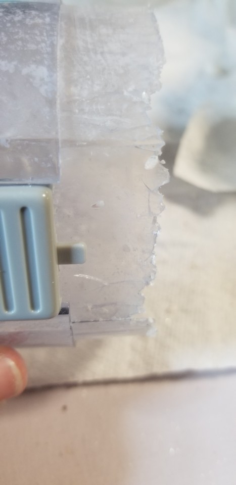 A close-up photograph of the extremely cracked and broken plastic edge of a nut grinder that I am now hesitant to use again, for fear of mortal peril and also plastic bits in my future face cream.