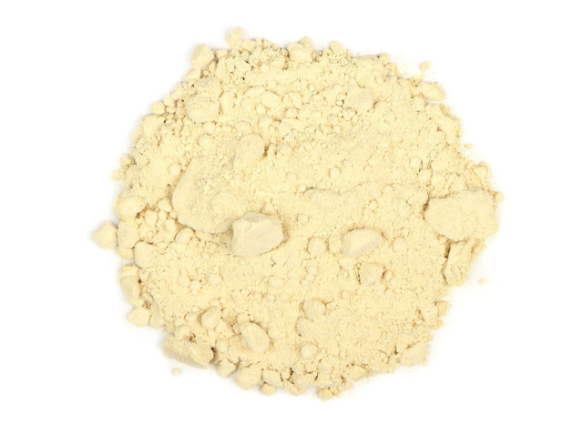 A top-view marketing photograph of a cream-colored, clumping powder.